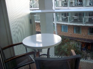 Photo of our Central Park balcony table and chairs overlooking the open-air core of the park. 
