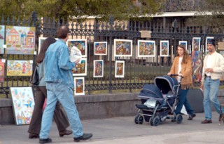 Photo of tourists strolling the art area of the French Quarter goes here.