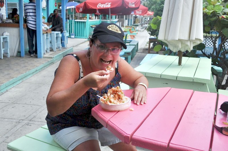 Lizz Dinnigan dines on fresh conch salad at Arawak Key, the Bahamas.*