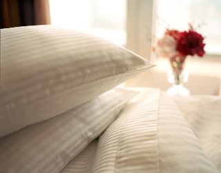 Photo of Holland America bed linens and pillows goes here.