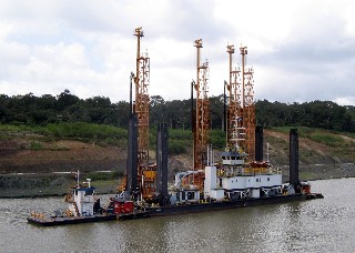 Photo of the blasting rigs used to deepen the channel goes here.