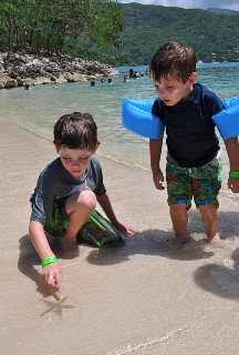 Photo of kids with a starfish on the beach goes here.