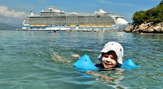 Photo of child with Oasis of the Seas in the background goes here.