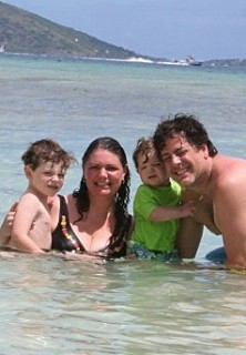 Photo of the entire Dinnigan family at the beach in St. Thomas goes here.
